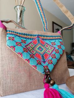 a purse with tassels hanging from it