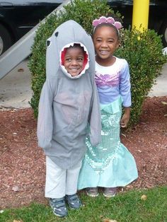 two children dressed in costumes standing next to each other