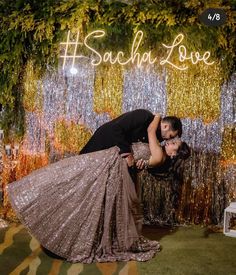 a man and woman kissing in front of a backdrop with the words sauch love on it