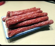 several pieces of raw meat on a blue and white plate