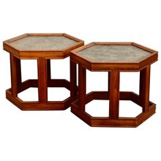 two wooden tables with marble top sitting side by side on a white background in the style of hexagonals