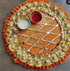 a decorative tray with two bowls on it and some other items in the middle, sitting on a table