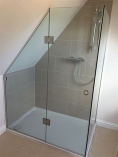 a glass shower door in the corner of a bathroom