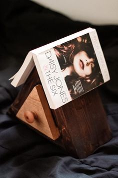 a book is sitting on top of a wooden stand