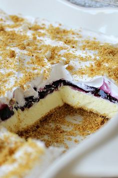 a close up of a dessert on a plate with crumbs and powdered sugar