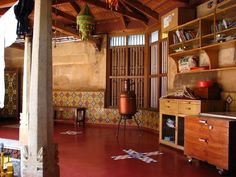 a room with wooden shelves and colorful tiles on the floor