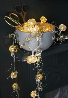 a bowl with scissors and other items hanging from it