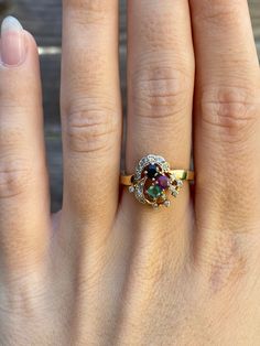 Total Weight: 3.5 grams Size: 6.5 Band Width: 2.1-2.5mm  Spinel: 2.6mm Diamonds: 1.1mm Emerald: 2.9mm Condition: In great condition showing little wear with no damage.  All gold has been thoroughly checked with an Olympus XRF spectrometer. It is guaranteed 14k gold.  All our jewelry is properly washed and disinfected to ensure customers get clean items with every order.  Returns accepted but may be subjected to a restock fee.  Please message with any questions:) Oval Yellow Gold Emerald Ring With Multi-stone, Oval Yellow Gold Emerald Ring With Multiple Stones, Multicolor Oval Heirloom Ring, Heirloom Style Multicolor Oval Rings, Heirloom Multicolor Oval Rings, Collectible 14k Gold Multi-stone Rings, Collectible Multi-stone 14k Gold Rings, Formal Multicolor Round Cut Rings, Gold Oval Multi-stone Birthstone Ring