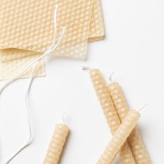 three pieces of paper are tied together with twine and thread on the table, next to each other