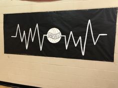 a black and white sign with the word basketball on it in front of a wall