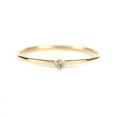 Dainty 1.75mm Diamond Ring -Recycled yellow gold (choose 10K or 14K) -1.75mm salt and pepper diamond diamond (gray diamond) -1mm band (round silhouette) -Bezel is set on top of band for stacking -Polished finish (satin finish available upon request) -Full, half and quarter sizes 2-10 (contact me for other sizes) -Free US shipping PRODUCTION TIME: Rings take approximately 5-7 business days to make. PACKAGING: All purchases are shipped in a jewelry box stamped with my logo--perfect for giving as a Yellow Gold Stacking Rings, Olive Jewelry, Tiny Diamond Ring, Gold Stacking Ring, Gray Diamond, Tiny Rings, Pepper Diamond, Bezel Ring, Gold Ring Stack