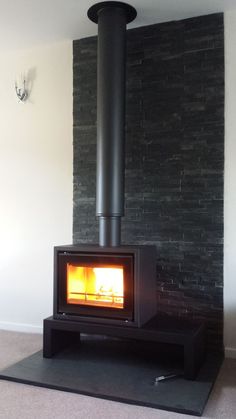 a wood burning stove sitting inside of a living room