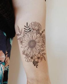 a woman's arm with a flower tattoo on the left side of her body