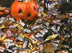 a pile of candy with a jack - o'- lantern in the middle