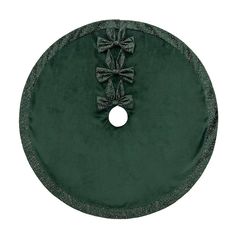 a round green velvet table cloth with bows on it's center and an appliqued bow at the top