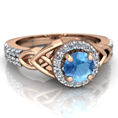 a white gold ring with a blue diamond in the center