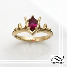 Goron's Ruby is the second stone gathered by Link on his quest in the game The legend of Zelda: the Ocarina of Time. And now I have it available to order here in my shop! Much like my other two spiritual stone rings, I wanted the band to be something that connected with the center piece. In this one, I gave the ring a fiery motif with a milgrain pattern for that classic feel. These rings are made to order. Each one is crafted from scratch, no molds are used. Please select your ring size when che Loz Jewelry, Zelda Rings, Zelda Jewelry, Zelda Wedding, Geeky Girls, Ruby Engagement Ring, Ruby Jewelry, The Legend Of Zelda, Emerald Engagement Ring