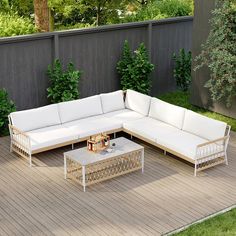 a white couch sitting on top of a wooden floor next to a table and chairs