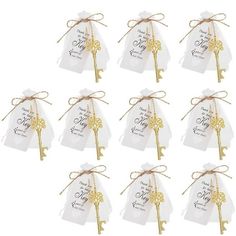 twelve gold key tags with ribbons tied to them