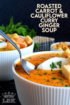 two bowls of roasted carrot and cauliflower curry glaze soup with bread croutons