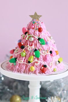 a pink christmas tree cake on a white plate