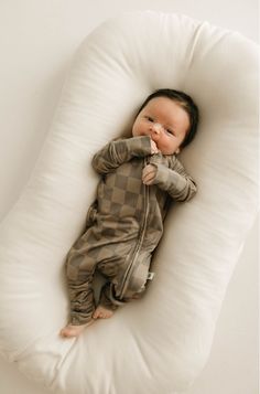 "Wrap your little one in comfort and style with our FF Checkerboard Bamboo Zip Pajamas. The natural bamboo fabric is soft on baby's skin and the brown on brown checkerboard design adds a touch of sophistication. Keep your baby cozy and fashionable all night long!" Made of the softest premium bamboo. Durable and well designed your little ones can sleep and play in these cozy pajamas. Our smallest sizes have rollover cuffs on the hands and all of the one piece sizes have cuffs on the feet giving you the option to go footless or footed without changing outfits. Sizes available in newborn - 24 months Material : 95% bamboo viscose / 5% spandexCare Instructions : Wash with like colorsTumble dry on low or hang dryExclusively available at Forever French Baby *Excluded from all discounts**Shipping French Baby, Cozy Pajamas, Bamboo Clothing, Christmas Blankets, Bamboo Fabric, Girls Pajamas, Baby Skin, Swim Accessories