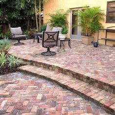 an outdoor patio with brick steps and seating