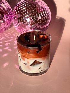 a candle that is sitting in front of some disco balls