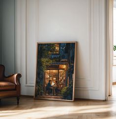 a painting is on the floor in front of a chair and wall with an open window