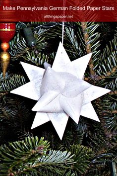 a white ornament hanging from a christmas tree