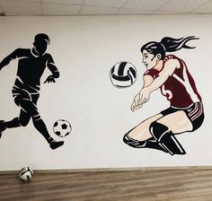 a woman kicking a soccer ball in front of a wall mural