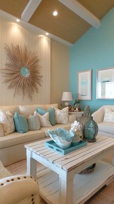 a living room filled with white furniture and blue accents