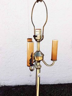 an old fashioned brass candelabra with two candles