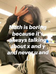 a woman with black hair sitting on top of a desk