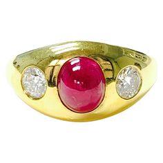 Three stone ruby and diamond ring handcrafted in 14k yellow gold. The details are as follows : oval ruby weight : 2.63 carat diamond weight : 0.56 carat Metal : 14k yellow gold Measurements : 0.40" tapered to 0.10" Oval Red Ruby Ring With Three Stones, Luxury Oval Three-stone Ruby Ring, 14k Gold Ruby Ring With Brilliant Cut Oval Shape, Oval Brilliant Cut Ruby Ring In 14k Gold, Red Diamond Oval Cabochon Ring, Oval Cabochon Ruby Ring In Yellow Gold, Oval Cabochon Ruby And Diamond Ring, Oval Ruby Ring With Diamond Accents In 14k Gold, Yellow Gold Diamond Ring With Oval Cabochon