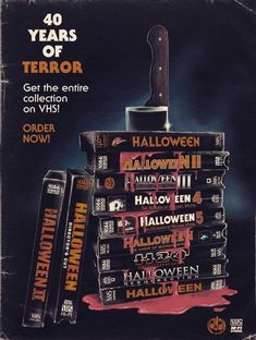 a stack of halloween books with a knife sticking out of the top and on top