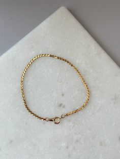 Add a touch of elegance to any outfit with the Kaylor Bracelet in Gold. Featuring a twisted gold chain, this bracelet adds a sophisticated and stylish touch. Perfect for any occasion, the Kaylor Bracelet will elevate your look and make you feel confident and glamorous. Adjustable Gold Plated Box Chain Bracelet, Elegant Gold Snake Chain Bracelets, Elegant Gold Bracelet With Snake Chain, Adjustable Jubilee Snake Chain Bracelet, Gold-plated Jubilee Bracelet With Snake Chain, Gold Plated Jubilee Bracelet With Snake Chain, Dainty Gold Jubilee Bracelet, Elegant Gold Snake Chain Bracelet With Lobster Clasp, Gold Minimalist Box Chain Bracelet