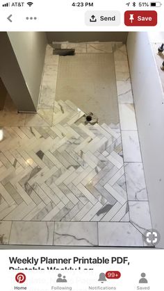 a bathroom with marble flooring and white walls