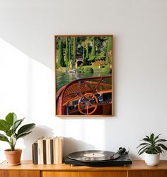 a record player sitting on top of a wooden table next to a potted plant