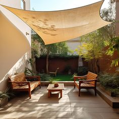 two wooden benches sitting under an awning in a courtyard area with trees and plants