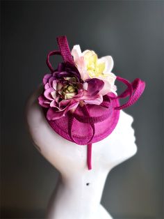 Featuring delicate flowers on a pink base, this fascinator hat adds a touch of romance and sophistication to any occasion. Lightweight and designed for a secure fit, allowing you to enjoy your masquerade event or tea party in comfort and style! Age Group/Gender - Adult/Women Size/Type - One size fits all adults Color - Pink Special Features - Flowers Whimsical Flower Costume Hats For Party, Spring Headband With Pinched Crown, Flower-shaped Party Fascinator With Flower Decoration, Floral Headpieces For Summer Garden Parties, Summer Flower Fascinator, Garden Party Flower Hat With Handmade Flowers, Elegant Pink Headband For Kentucky Derby, Floral Summer Party Costume Hats And Headpieces, Elegant Pink Headpiece With Structured Crown