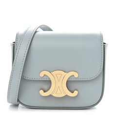 This is an authentic CELINE Shiny Calfskin Mini Triomphe in Soft Blue. This chic shoulder bag is crafted of calfskin leather in light blue. The bag features an adjustable leather shoulder strap, gold hardware, and a gold snap lock. This opens to a matching leather interior with a patch pocket. Luxury Light Blue Leather Shoulder Bag, Elegant Light Blue Shoulder Bag With Gold-tone Hardware, Celine Box, Bag Light, Black Cross Body Bag, Flap Bag, White Bag, Patch Pocket, Belt Bag