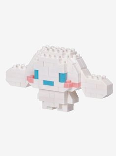 an animal made out of legos sitting on top of a white surface with blue eyes