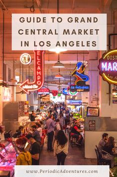 the inside of a market with neon signs and people walking around