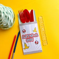 a cupcake and fork on a yellow table