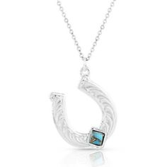 Silver Artistry shines with the Montana Diamond Horseshoe Necklace. A beautiful masterfully engraved silver finished horseshoe creates the pendant of the necklace. A diamond-shaped compressed turquoise with copper stone sits at the bottom of the horseshoe. At the top of the horseshoe attaches the 19 inch chain. Stone color will vary. Item has a silver finish. Product has turquoise stones. Item has a horseshoe design. Horseshoe Design, Horseshoe Pendant, Horseshoe Necklace, Tractor Supply, Silver Engraving, Turquoise Stones, Diamond Shaped, Accessories Jewelry Necklace, Women Accessories Jewelry