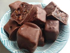 a blue and white plate topped with pieces of chocolate