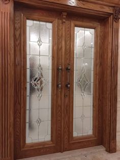 two wooden doors with glass panels on each side