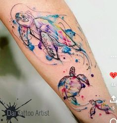 a colorful tattoo on the arm of a man with a turtle and watercolor splashs