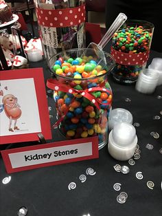 there is a candy jar on the table with cards and other candies in it